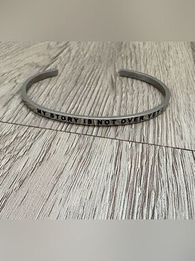 Mantraband Silver Bracelet
“My Story Isn’t Over Yet;” 🖤